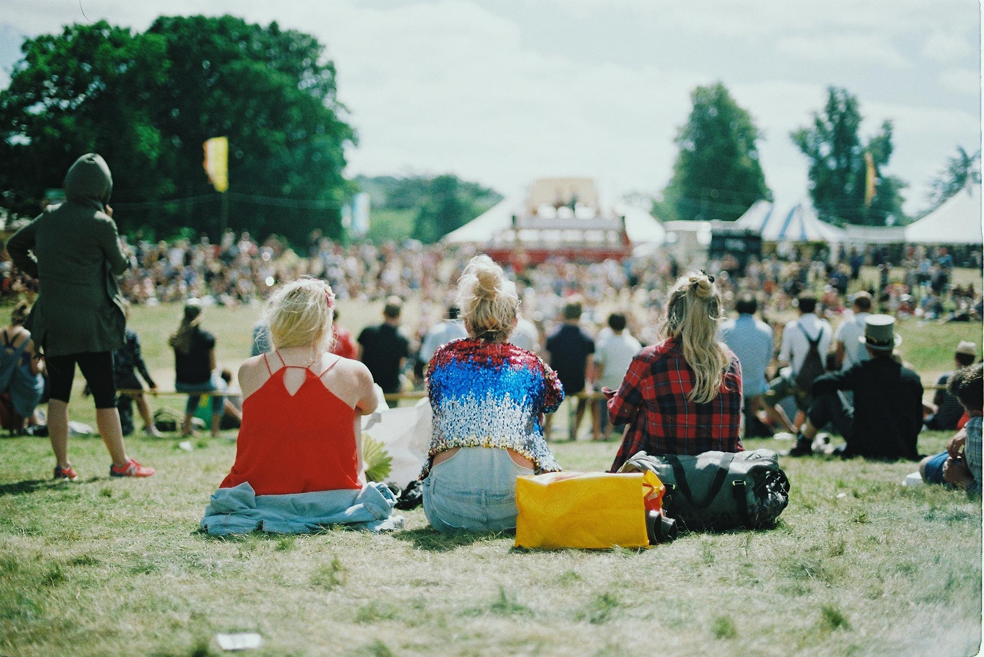 Colorfull dressed people sitting together in a park